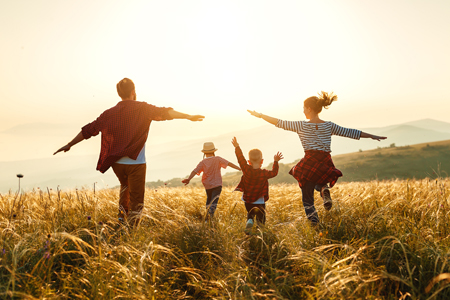 Happy,Volunteer,Family,Putting,Their,Hands,Together,On,A,Sunny